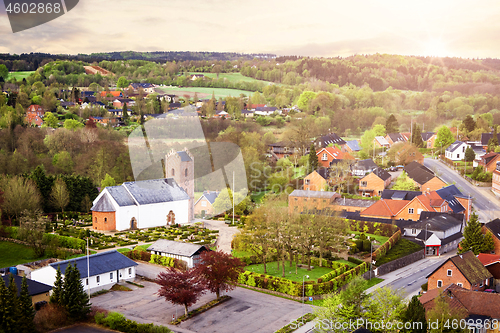 Image of Village with a church in the morning sunrise