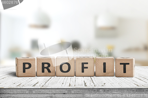 Image of Profit sign in a bright room on a wooden table