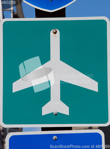 Image of Green and white airport road sign on pole