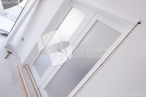 Image of double glass door with white wooden frame