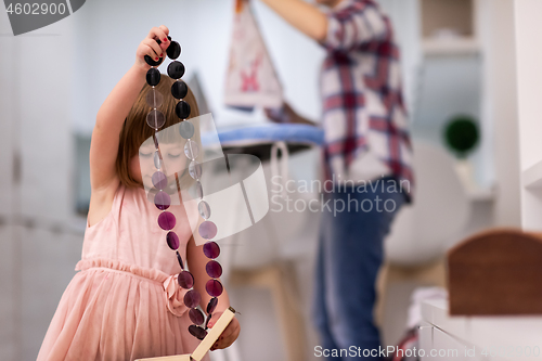 Image of mother and daughter spending time together at home