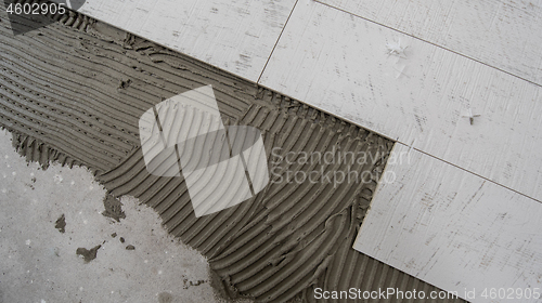 Image of Ceramic wood effect tiles and tools for tiler on the floor