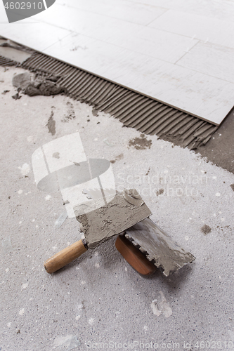 Image of Ceramic wood effect tiles and tools for tiler on the floor