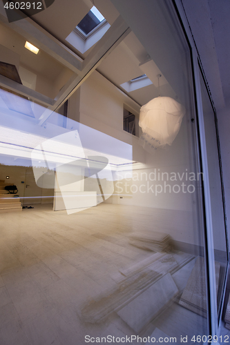 Image of outside view trough window on two level apartment interior