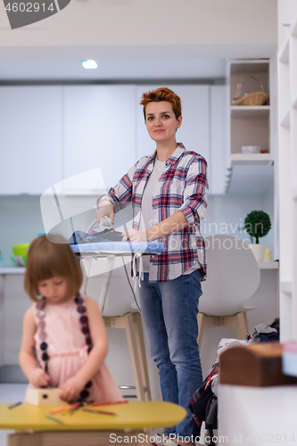 Image of mother and daughter spending time together at home