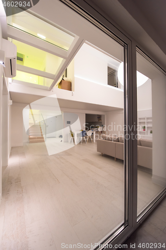 Image of outside view trough window on two level apartment interior