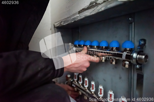 Image of engineer checking technical data of heating system