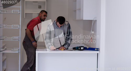 Image of workers installing a new kitchen