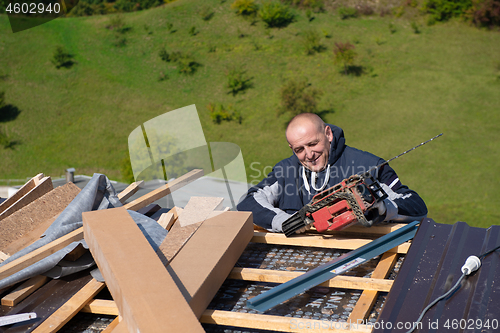 Image of Construction worker installing a new roof