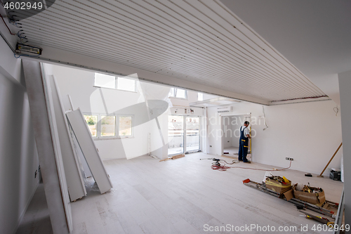 Image of carpenters installing glass door with a wooden frame