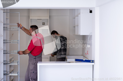 Image of workers installing a new kitchen