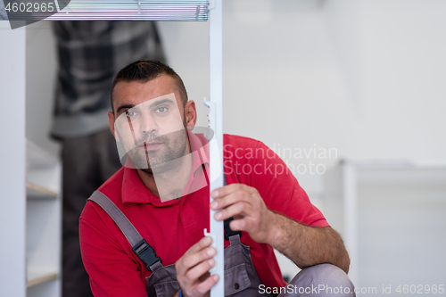 Image of worker installing a new kitchen