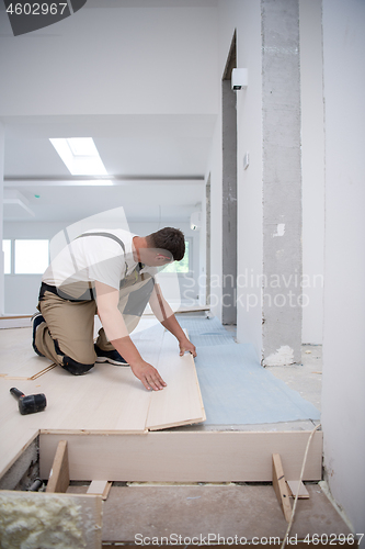 Image of Worker Installing New Laminated Wooden Floor