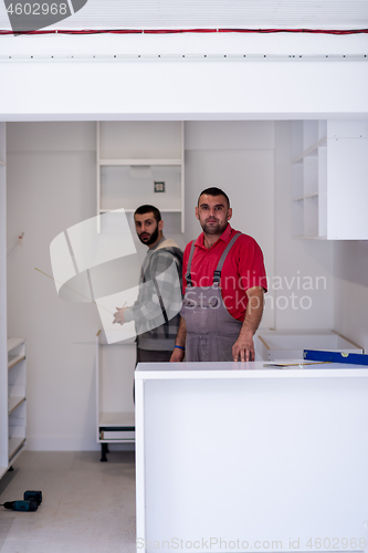 Image of workers installing a new kitchen