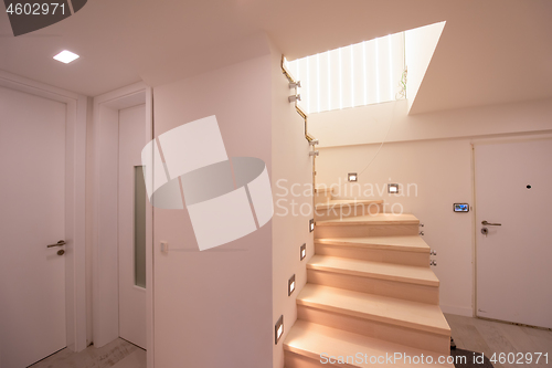 Image of stylish interior with wooden stairs