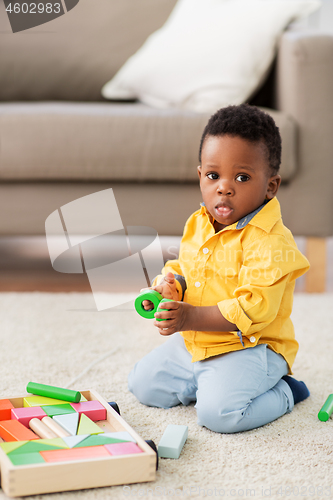 Image of african american baby boy playing with toy blocks