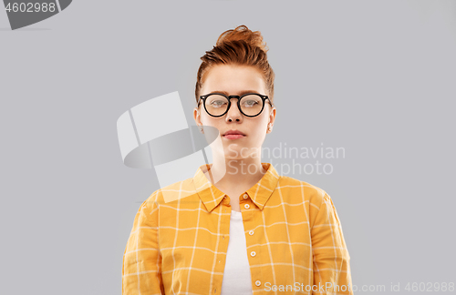 Image of red haired teenage student girl in glasses