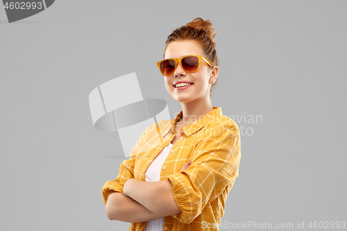 Image of smiling red haired teenage girl in sunglasses