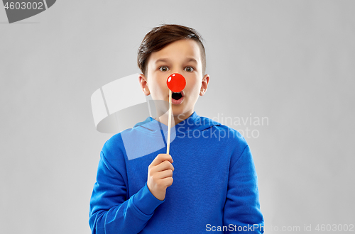 Image of shocked boy in blue hoodie with red clown nose