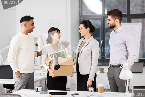 Image of new female employee with colleagues at office