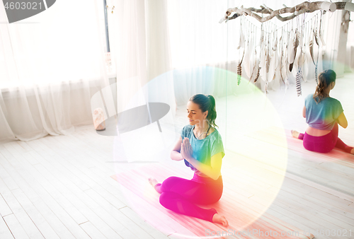 Image of woman meditating at yoga studio