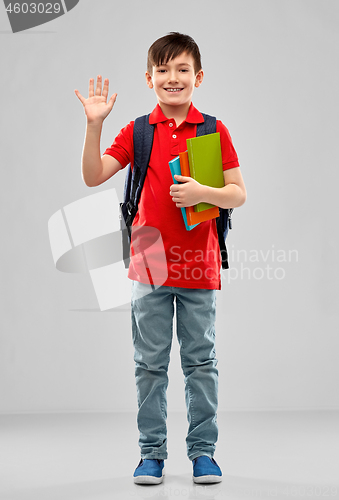 Image of smiling student boy with books and school bag