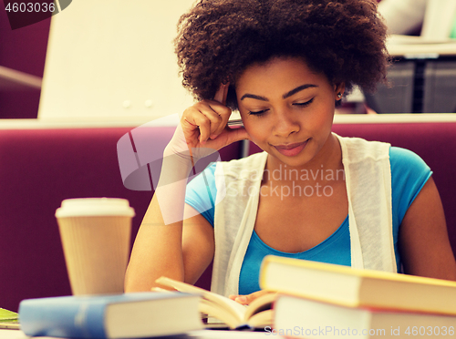 Image of student girl with books and coffee on lecture