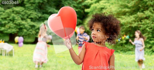 Image of african american girl with heart shaped balloon