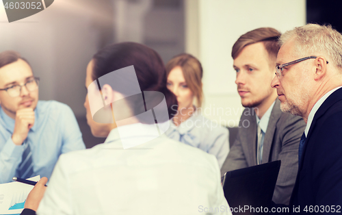 Image of smiling business people meeting in office