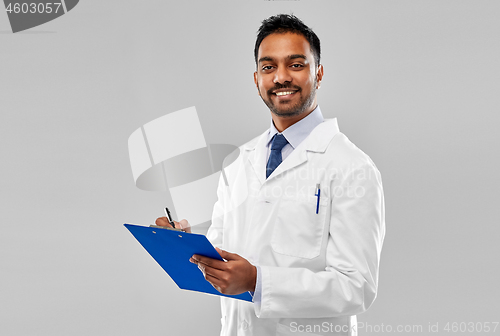 Image of smiling indian doctor or scientist with clipboard