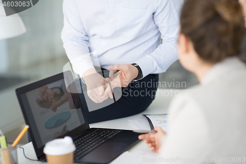 Image of close up of businessman giving arguments at office