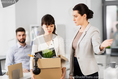 Image of fired sad female office worker leaving