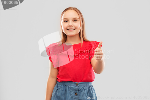 Image of beautiful smiling girl showing thumbs up