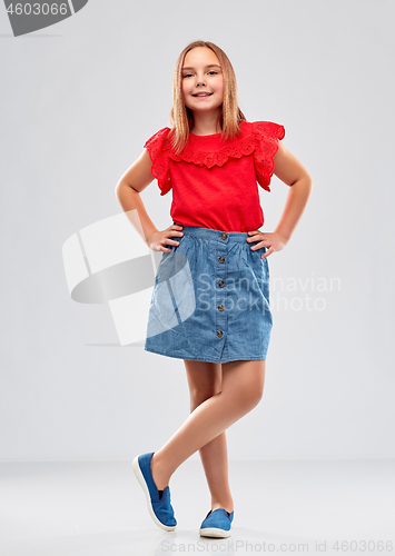 Image of beautiful smiling girl in red shirt and skirt