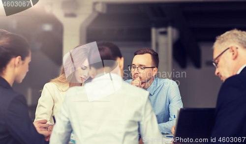 Image of smiling business people meeting in office