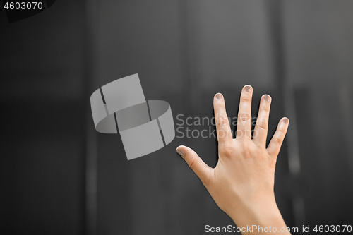 Image of hand using black interactive panel