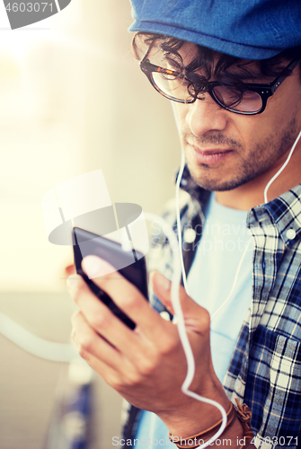 Image of man with earphones and smartphone listening music