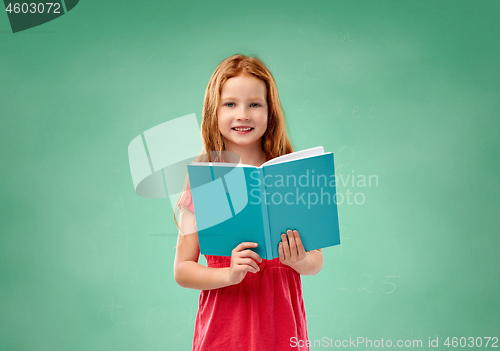 Image of red student girl with book over school chalk board