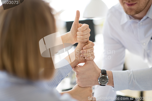 Image of group of business team making thumbs up gesture