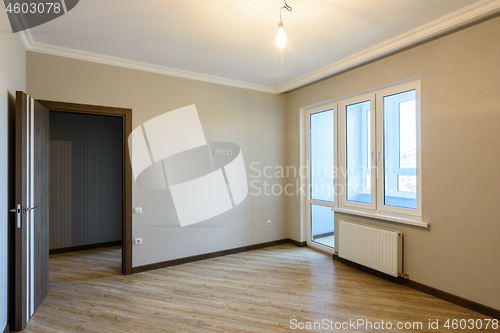 Image of The interior of the room is unfurnished with new renovations, the front door and the balcony exit