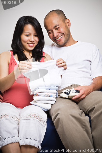 Image of Happy expecting asian couple