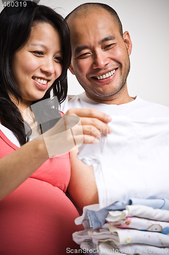 Image of Happy expecting asian couple