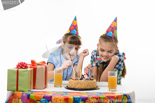 Image of Children eat a birthday cake with a spoon, isolated on a white background