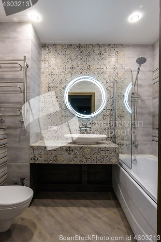 Image of Interior of a stylish modern combined bathroom and toilet