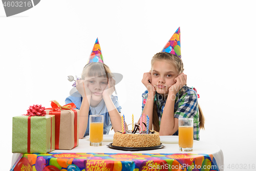 Image of Children are waiting for the cake to be eaten at the holiday table