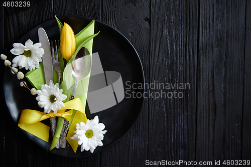 Image of Easter spring table dishware composition with yellow tulip flower