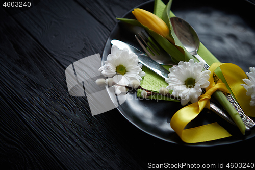 Image of Easter spring table dishware composition with yellow tulip flower