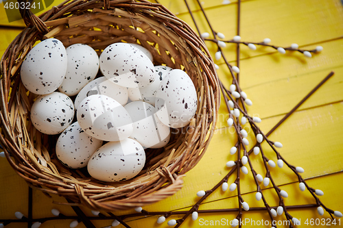 Image of Whole chicken eggs in brown wicker basket. The concept of Easter Holidays