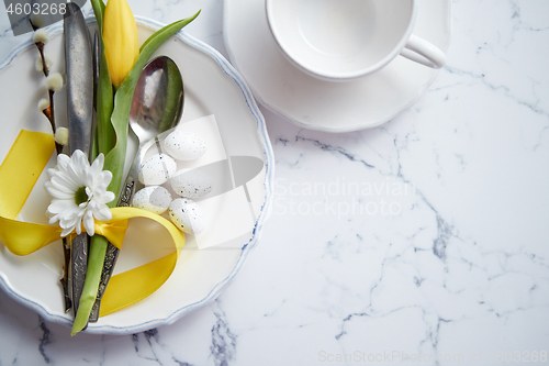 Image of Spring Easter Table setting at white marble table. Top view