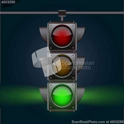 Image of Realistic traffic lights with green lamp on, hanging in night sky.